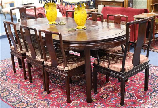 A Chinese hardwood extending dining table and eight chairs